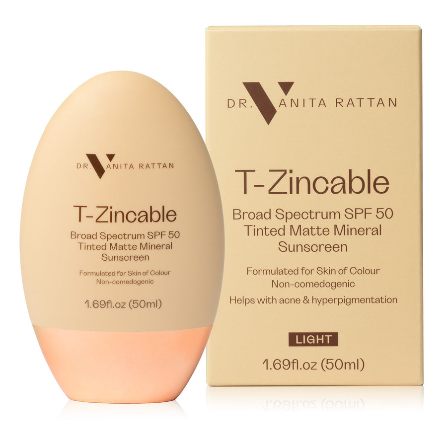 DR. VANITA RATTAN T-Zincable Broad Spectrum SPF 50 Tinted Matte Mineral Sunscreen in 'Light' shade, shown in an egg-shaped bottle next to its beige packaging box.