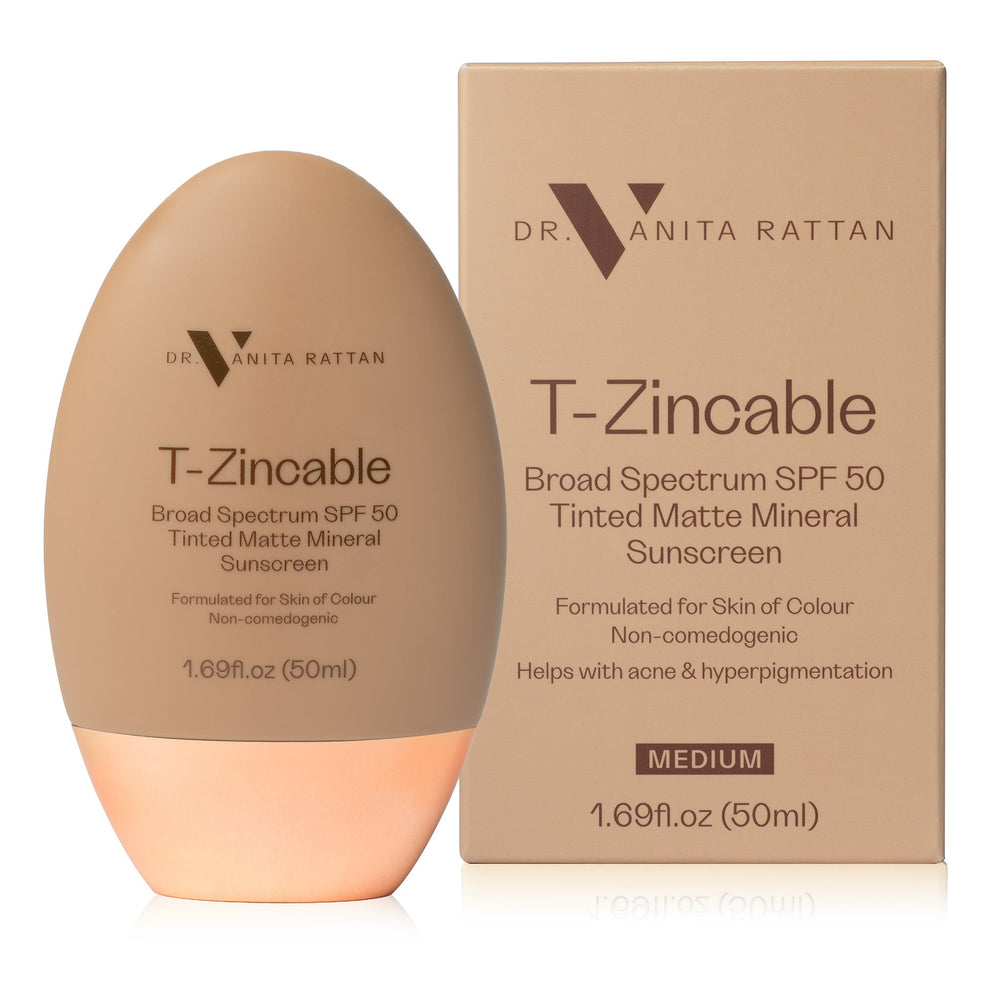 Dr. Vanita Rattan T-Zincable Broad Spectrum SPF 50 Tinted Matte Mineral Sunscreen in a medium shade, shown as an egg-shaped bottle next to its cardboard packaging box on a white background.
